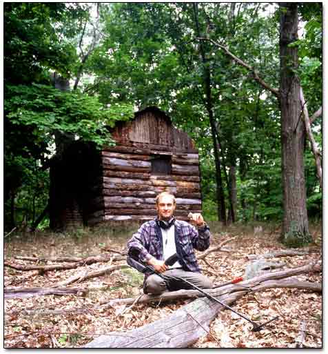 Sergei in Front of the Log Cabin