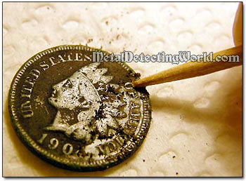 Cleaning Coin with a Toothpick
